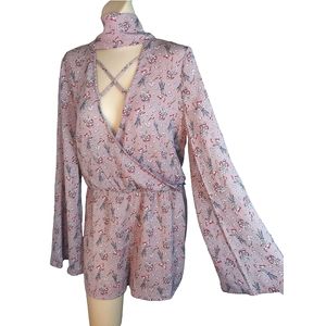 Flowy floral romper deep plunge with an open back and rear neck tie detail